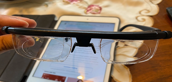 SmartFocus glasses holding them in front of a smartphone